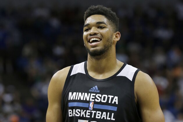 Minnesota Timberwolves center Karl-Anthony Towns laughs at a teammate during an NBA basketball scrimmage in Minneapolis, Wednesday, July 8, 2015.  (AP Photo/Ann Heisenfelt)