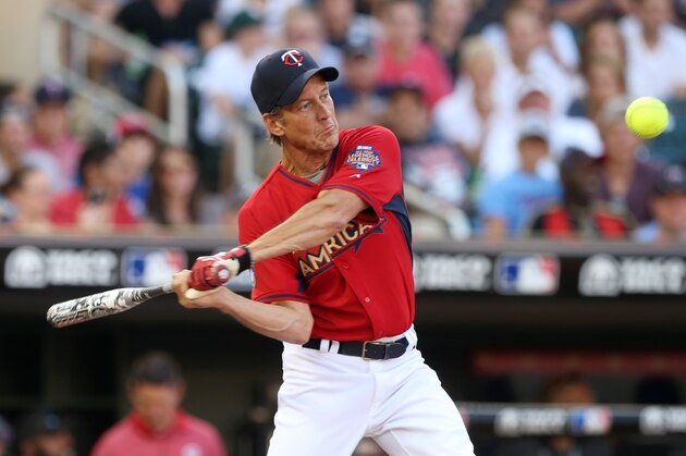 Actor James Denton bats during the All-Star Legends & Celebrity Softball Game, Sunday, July 13, 2014, in Minneapolis. (AP Photo/Jim Mone)