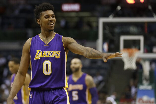 Los Angeles Lakers' Nick Young gestures to a fan during an NBA basketball game against the Milwaukee Bucks Wednesday, Feb. 4, 2015, in Milwaukee. (AP Photo/Aaron Gash)
