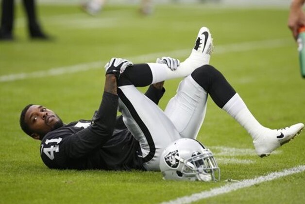 Oakland Raiders' Jonathan Dowling stretches before an NFL football game against the Miami Dolphins, Sunday, Sept. 28, 2014, at Wembley Stadium in London. (AP Photo/Lefteris Pitarakis)