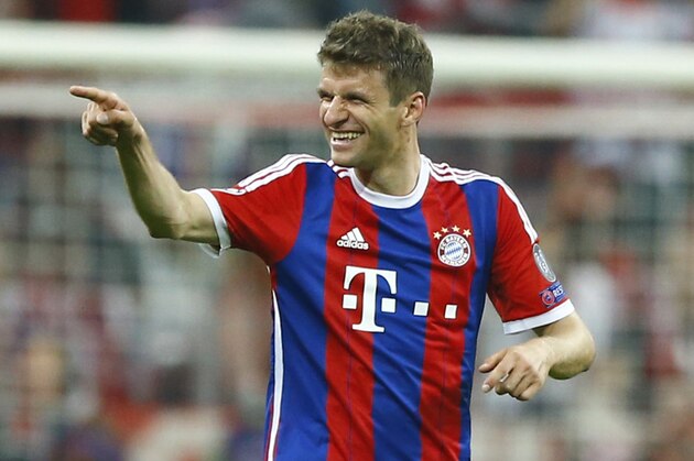 Bayern's Thomas Mueller celebrates after scoring his side's 4rth goal during the soccer Champions League quarterfinal second leg match between Bayern Munich and FC Porto at the Allianz Arena in Munich, southern Germany, Tuesday, April 21, 2015. (AP Photo/Matthias Schrader)