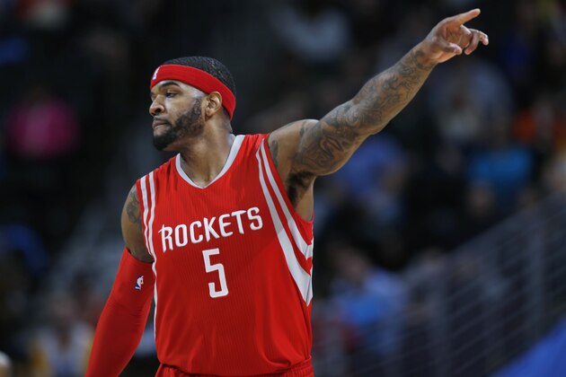 Houston Rockets forward Josh Smith acknowledges his teammates after scoring against the Denver Nuggets during the third quarter of an NBA basketball game Saturday, March 7, 2015, in Denver. Houston won 114-100. (AP Photo/David Zalubowski)