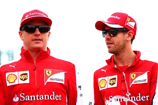 NORTHAMPTON, ENGLAND - JULY 05:  Sebastian Vettel of Germany and Ferrari speaks with Kimi Raikkonen of Finland and Ferrari during the drivers' parade before the Formula One Grand Prix of Great Britain at Silverstone Circuit on July 5, 2015 in Northampton, England.  (Photo by Mark Thompson/Getty Images)