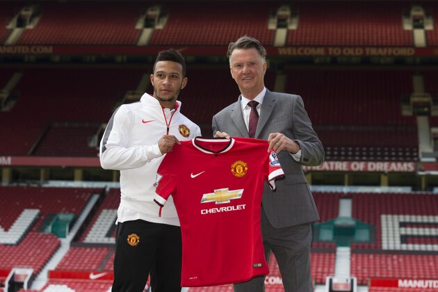 Manchester United's new player Memphis Depay poses  for photographs with manager Louis van Gaal at Old Trafford Stadium, Manchester, England, Friday July 10, 2015. The 21 year old Dutch international recently joined his Manchester United team-mates for the first time since his  move from PSV Eindhoven. (AP Photo/Jon Super)