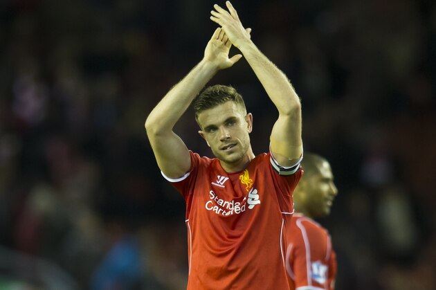 Liverpool's Jordan Henderson applauds supporters after his team's 2-0 win during the English Premier League soccer match between Liverpool and Newcastle at Anfield Stadium, Liverpool, England, Monday, April 13, 2015. (AP Photo/Jon Super)