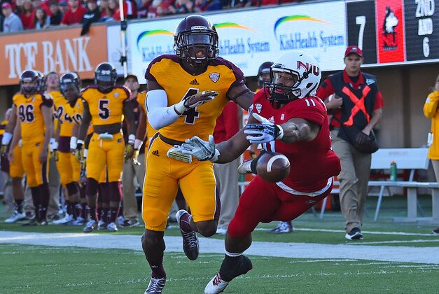 Oct 11, 2014; DeKalb, IL, USA; Northern Illinois Huskies wide receiver Juwan Brescacin (11) attempts to make a catch against Central Michigan Chippewas defensive back Brandon Greer (4) during the first quarter at Huskie Stadium. Mandatory Credit: Mike DiNovo-USA TODAY Sports