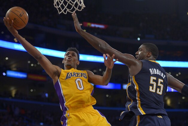 Los Angeles Lakers forward Nick Young puts up a shot as Indiana Pacers center Roy Hibbert defends during the second half of an NBA basketball game, Tuesday, Jan. 28, 2014, in  Los Angeles. (AP Photo/Mark J. Terrill)