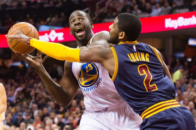 CLEVELAND, OH - FEBRUARY 26: Draymond Green #23 of the Golden State Warriors tries to shoot over Kyrie Irving #2 of the Cleveland Cavaliers during the first half at Quicken Loans Arena on February 26, 2015 in Cleveland, Ohio. NOTE TO USER: User expressly acknowledges and agrees that, by downloading and or using this photograph, User is consenting to the terms and conditions of the Getty Images License Agreement. (Photo by Jason Miller/Getty Images)
