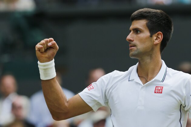 Novak Djokovic of Serbia celebrates winning the second set against Roger Federer of Switzerland during their men's singles final match at the All England Lawn Tennis Championships in Wimbledon, London, Sunday, July 6, 2014. (AP Photo/Ben Curtis)