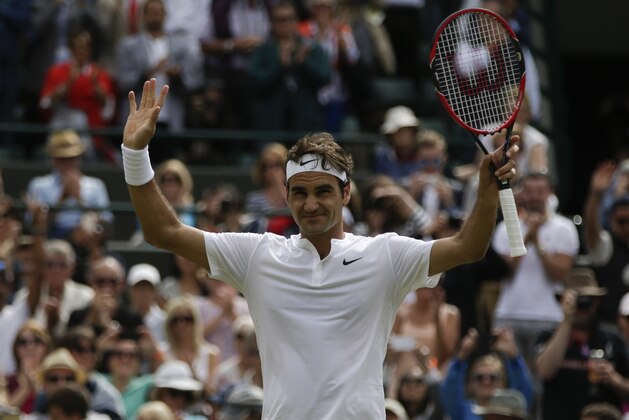 Roger Federer of Switzerland celebrates after  winning the quarterfinal singles match against Gilles Simon of France, at the All England Lawn Tennis Championships in Wimbledon, London, Wednesday July 8, 2015.  Federer won 6-3, 7-5, 6-2. (AP Photo/Pavel Golovkin)