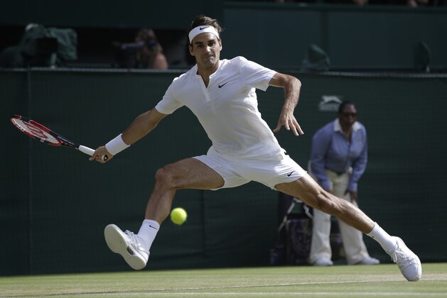 Roger Federer of Switzerland returns a shot to Andy Murray of Britain, during their men's singles semifinal match at the All England Lawn Tennis Championships in Wimbledon, London, Friday July 10, 2015. (AP Photo/Pavel Golovkin)