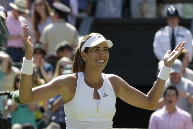 Garbine Muguruza of Spain celebrates winning the women's singles semifinal match against Agnieszka Radwanska of Poland at the All England Lawn Tennis Championships in Wimbledon, London, Thursday July 9, 2015. (AP Photo/Alastair Grant)