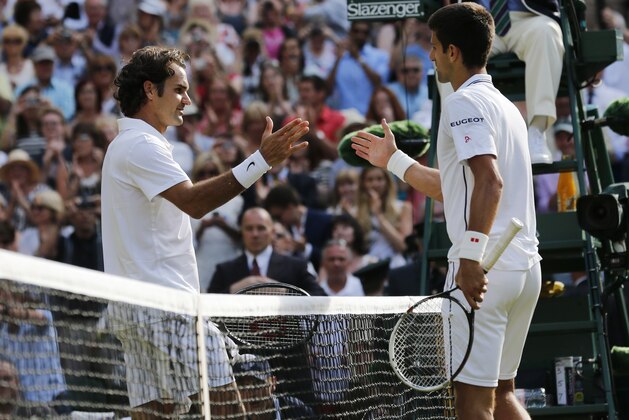 Novak Djokovic of Serbia, right, shakes hands after defeating Roger Federer of Switzerland in the men's singles final at the All England Lawn Tennis Championships in Wimbledon, London, Sunday July 6, 2014. (AP Photo/Ben Curtis)