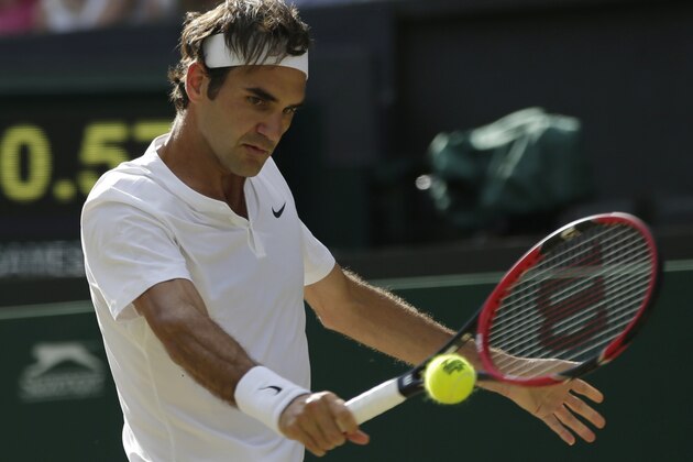 Roger Federer of Switzerland returns a ball to Andy Murray of Britain during their men's singles semifinal match at the All England Lawn Tennis Championships in Wimbledon, London, Friday July 10, 2015. (AP Photo/Pavel Golovkin)