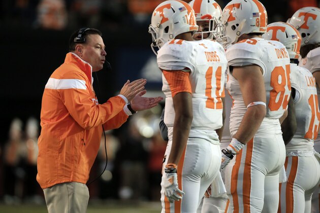 Tennessee head coach Butch Jones talks to his players in the second quarter of an NCAA college football game against Vanderbilt Saturday, Nov. 29, 2014, in Nashville, Tenn. (AP Photo/Mark Humphrey)