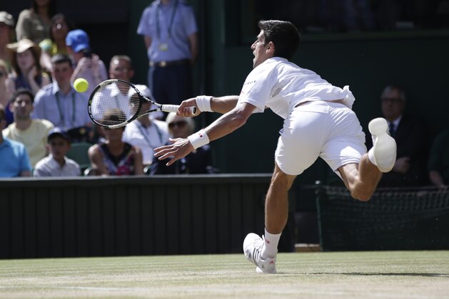 Novak Djokovic of Serbia makes a return to  Richard Gasquet of France during their men's singles semifinal match at the All England Lawn Tennis Championships in Wimbledon, London, Friday July 10, 2015. (AP Photo/Pavel Golovkin)