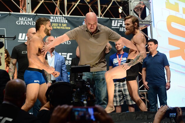 Jul 10, 2015; Las Vegas, NV, USA; UFC president Dana White (center) separates Conor McGregor (right) and Chad Mendes (left) during weigh-ins for UFC 189 at MGM Grand Garden Arena. Mandatory Credit: Joe Camporeale-USA TODAY Sports