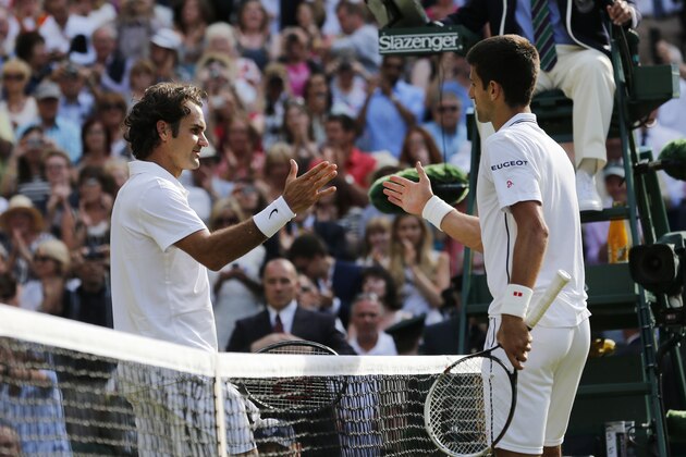 Novak Djokovic of Serbia, right, shakes hands after defeating Roger Federer of Switzerland in the men's singles final at the All England Lawn Tennis Championships in Wimbledon, London, Sunday July 6, 2014. (AP Photo/Ben Curtis)