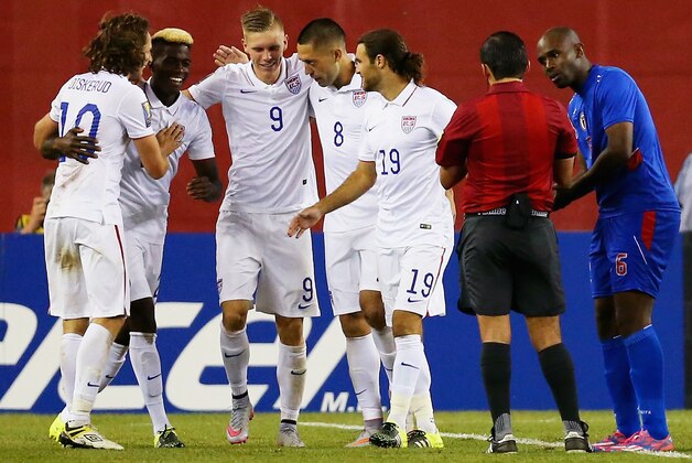 FOXBORO, MA - JULY 10:  Teammates congratulate Clint Dempsey #8 of United States after he scored a goal as Frantz Bertin #6 of Haiti, right, disputes the call during the 2015 CONCACAF Gold Cup Group A match between United States and Haiti at Gillette Stadium on July 10, 2015 in Foxboro, Massachusetts.  (Photo by Maddie Meyer/Getty Images)