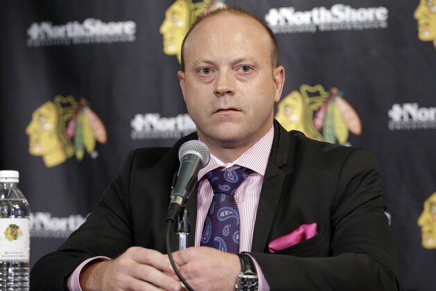 Chicago Blackhawks Vice President/General Manager Stan Bowman, listens to the media during a news conference at the United Center in Chicago, Wednesday, July 16, 2014. The Blackhawks recently agreed to eight-year contract extensions with Toews and Kane. (AP Photo/Nam Y. Huh)
