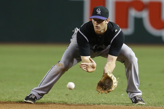 Colorado Rockies second baseman DJ LeMahieu makes the play for the out against the Arizona Diamondbacks in the first inning during a baseball game, Friday, July 3, 2015, in Phoenix. (AP Photo/Rick Scuteri)