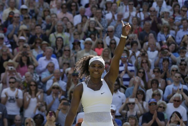 Serena Williams of the United States celebrates as she defeats Maria Sharapova of Russia in their women's singles semifinal match at the All England Lawn Tennis Championships in Wimbledon, London, Thursday July 9, 2015. Williams won 6-2, 6-4.  (AP Photo/Alastair Grant)