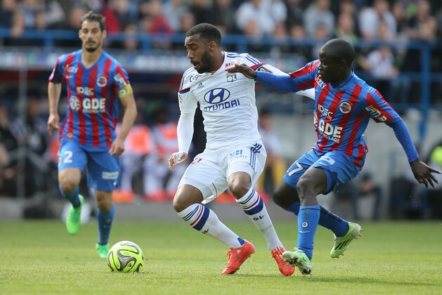 Lyon's Alexandre Lacazette, left, challenges for the ball with Caen's Ngolo Kante during their French League One soccer match, in Caen, western France, Saturday, May 9, 2015. Caen won 3-0. (AP Photo/David Vincent)