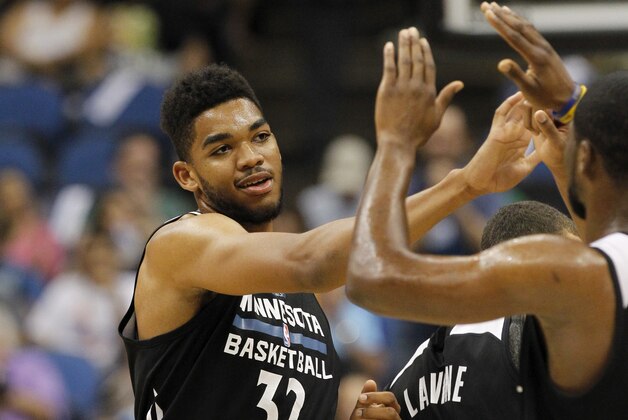 Minnesota Timberwolves center Karl-Anthony Towns (32) is introduced during an NBA basketball scrimmage in Minneapolis, Wednesday, July 8, 2015.  (AP Photo/Ann Heisenfelt)