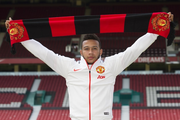 Manchester United's new player Memphis Depay poses for photographs at Old Trafford Stadium, Manchester, England, Friday July 10, 2015. The 21 year old Dutch international recently joined his Manchester United teammates for the first time since his move from PSV Eindhoven. (AP Photo/Jon Super)