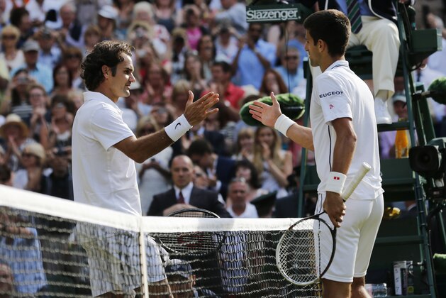 Novak Djokovic of Serbia, right, shakes hands after defeating Roger Federer of Switzerland in the men's singles final at the All England Lawn Tennis Championships in Wimbledon, London, Sunday July 6, 2014. (AP Photo/Ben Curtis)