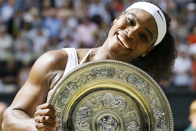 Serena Williams of the United States holds up the trophy after winning the women's singles final against Garbine Muguruza of Spain, at the All England Lawn Tennis Championships in Wimbledon, London, Saturday July 11, 2015. (AP Photo/Kirsty Wigglesworth)