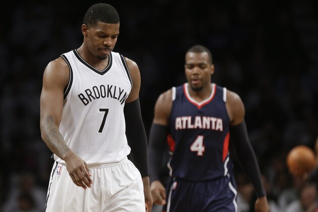 Brooklyn Nets' Joe Johnson (7) reacts as Atlanta Hawks' Paul Millsap (4) walks behind him during the second half of Game 6 in a first round NBA playoff basketball game Friday, May 1, 2015, in New York. The Hawks won the game 111-87. (AP Photo/Frank Franklin II)