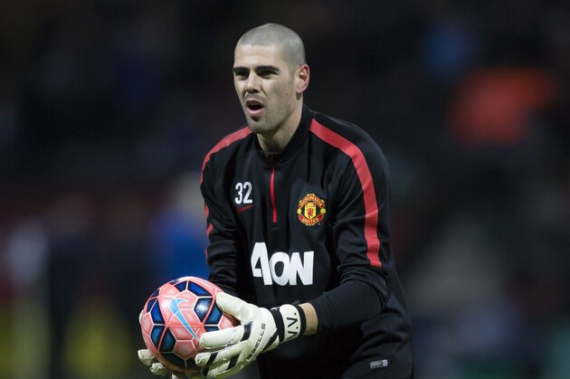Manchester United's substitute goalkeeper Victor Valdes warms up before the English FA Cup Fifth Round soccer match between Preston and Manchester United at Deepdale Stadium in Preston, England, Monday, Feb. 16, 2015.  (AP Photo/Jon Super)