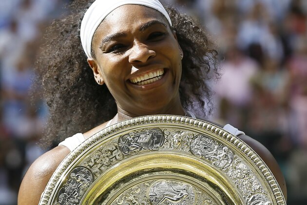 Serena Williams of the United States holds the trophy after winning the women's singles final against Garbine Muguruza of Spain, at the All England Lawn Tennis Championships in Wimbledon, London, Saturday July 11, 2015. (AP Photo/Kirsty Wigglesworth)