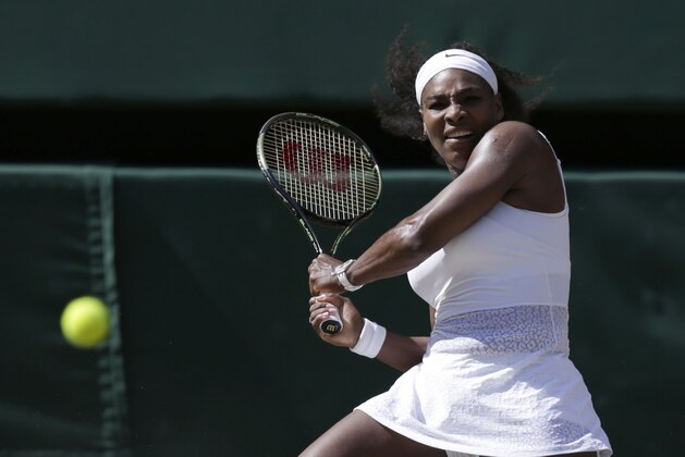 Serena Williams of the United States returns a ball to Garbine Muguruza of Spain during the women's singles final at the All England Lawn Tennis Championships in Wimbledon, London, Saturday July 11, 2015. (AP Photo/Pavel Golovkin)
