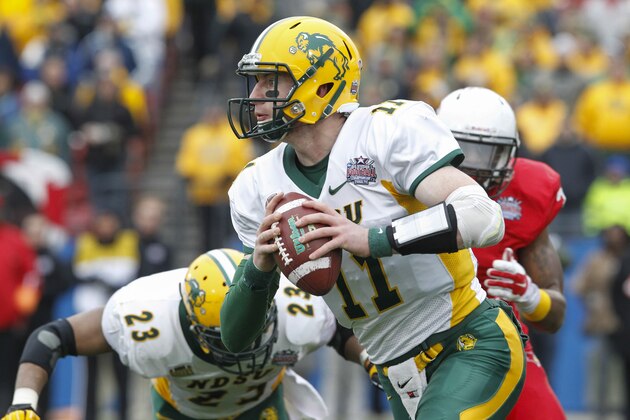 North Dakota State quarterback Carson Wentz (11) carries the ball during the FCS Championship NCAA college football game against Illinois State Saturday, Jan. 10, 2015, in Frisco, Texas.   North Dakota State won the game 29-27 for their fourth straight national championship.  (AP Photo/Tim Sharp)