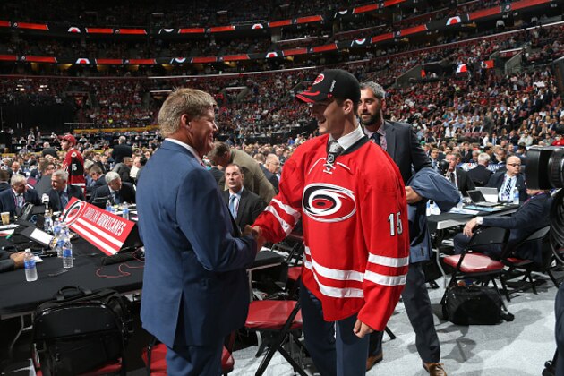 SUNRISE, FL - JUNE 26:  Noah Hanifin shakws the hand of a member of the Carolina Hurricanes after being selected fifth overall by the Carolina Hurricanes during Round One of the 2015 NHL Draft at BB&T Center on June 26, 2015 in Sunrise, Florida.  (Photo by Dave Sandford/NHLI via Getty Images)