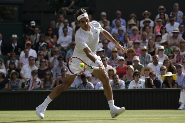 Roger Federer of Switzerland returns a shot to Andy Murray of Britain, during their men's singles semifinal match at the All England Lawn Tennis Championships in Wimbledon, London, Friday July 10, 2015. (AP Photo/Pavel Golovkin)