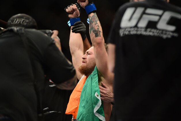 Jul 11, 2015; Las Vegas, NV, USA;  Conor McGregor (blue gloves) celebrates after defeating Chad Mendes (not pictured) in their interim featherweight title bout during UFC 189 at MGM Grand Garden Arena. McGregor won via second round TKO. Mandatory Credit: Joe Camporeale-USA TODAY Sports