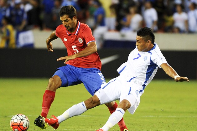 Costa Rica midfielder Celso Borges (5) dribbles the ball past El Salvador midfielder Darwin Ceren (7) during the first half of a CONCACAF Gold Cup soccer match, Saturday, July 11, 2015 in Houston. (AP Photo/Eric Christian Smith)