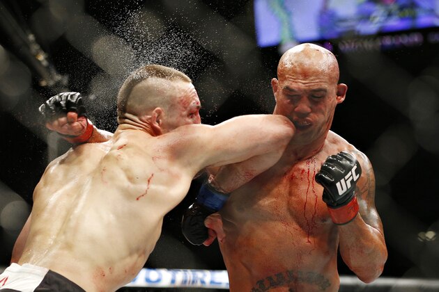 Rory MacDonald, left, and Robbie Lawler exchange blows in their welterweight title mixed martial arts bout at UFC 189 on Saturday, July 11, 2015, in Las Vegas. (AP Photo/John Locher)