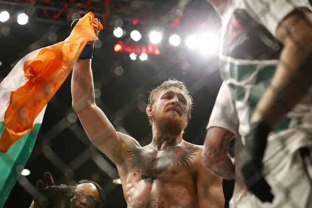 Conor McGregor celebrates after defeating Chad Mendes in their interim featherweight title mixed martial arts bout at UFC 189 Saturday, July 11, 2015, in Las Vegas. (AP Photo/John Locher)