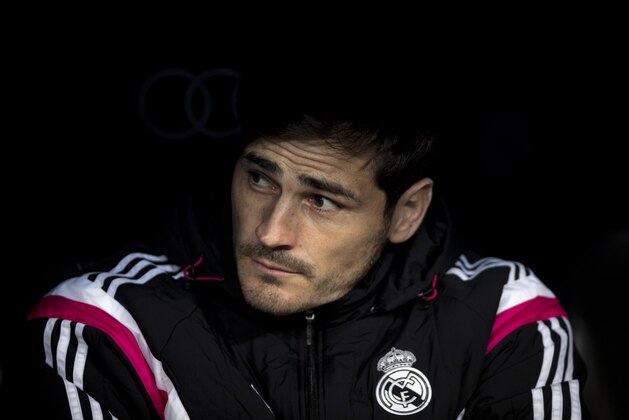 Real Madrid's goalkeeper Iker Casillas watches from the bench just before a La Liga soccer match between Real Madrid and Levante at the Santiago Bernabeu stadium in Madrid, Spain, Sunday, March 15, 2015. (AP Photo/Daniel Ochoa de Olza)