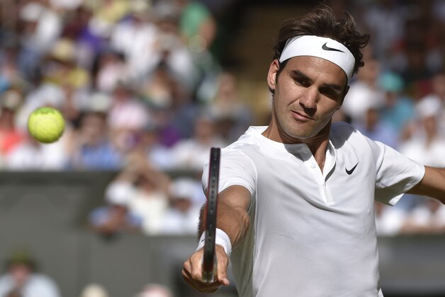 Andy Murray of Britain returns a shot to Roger Federer of Switzerland during the men's singles semifinal match at the All England Lawn Tennis Championships in Wimbledon, London, Friday July 10, 2015. (Toby Melville/Pool Photo via AP)