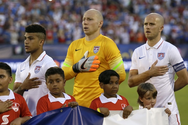 U.S. soccer players Clint Dempsey, right, Brad Guzan, center, and DeAndre Yedlin,  stand for the national anthem before a CONCACAF Gold Cup soccer match in Frisco, Texas, Tuesday, July 7, 2015. (AP Photo/LM Otero)