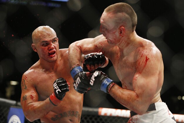 Robbie Lawler , left, lands a left hit to Rory MacDonald to end their welterweight title mixed martial arts bout at UFC 189 on Saturday, July 11, 2015, in Las Vegas. (AP Photo/John Locher)