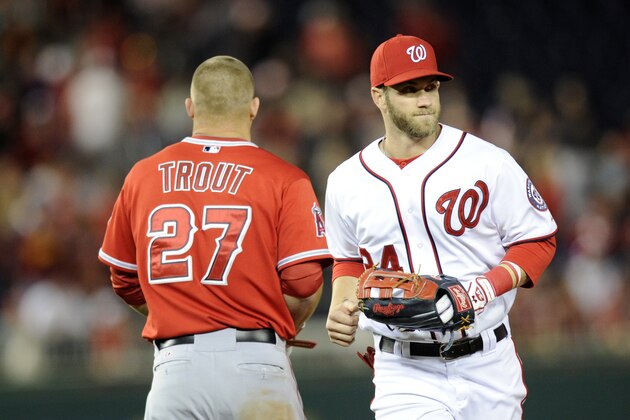 Washington Nationals left fielder Bryce Harper (34) runs from the field past Los Angeles Angels' Mike Trout (27) during the middle of the seventh inning of a baseball game, Monday, April 21, 2014, in Washington. The Angels won 4-2. (AP Photo/Nick Wass) Washington Nationals left fielder Bryce Harper (34) runs from the field past Los Angeles Angels' Mike Trout (27) during the middle of the seventh inning of a baseball game, Monday, April 21, 2014, in Washington. The Angels won 4-2. (AP Photo/Nick Wass)