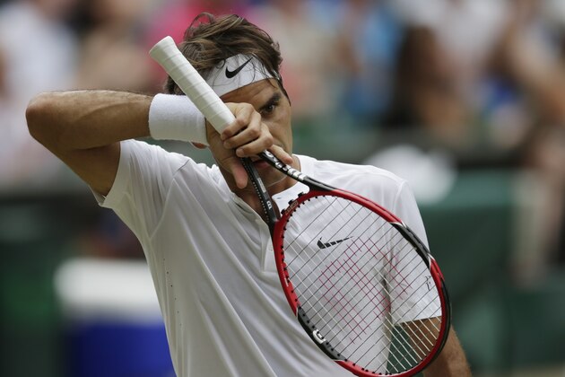 Roger Federer of Switzerland wipes his face during the men's singles final against Novak Djokovic of Serbia at the All England Lawn Tennis Championships in Wimbledon, London, Sunday July 12, 2015. (AP Photo/Pavel Golovkin)