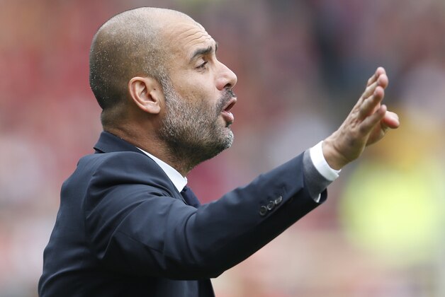 Bayern's head coach Pep Guardiola gestures during a German first division Bundesliga soccer match between SC Freiburg and Bayern Munich in Freiburg, Germany, Saturday, May 16, 2015. (AP Photo/Michael Probst)