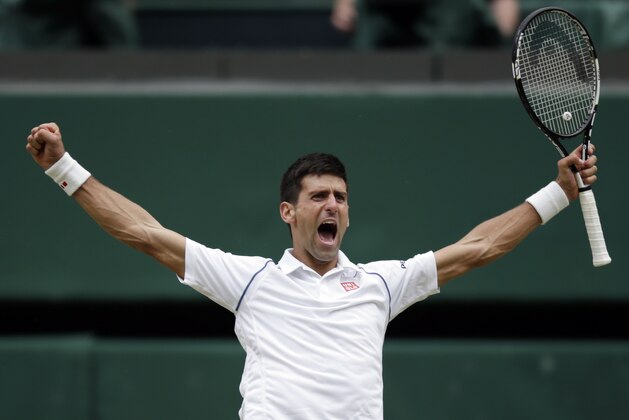 Novak Djokovic of Serbia celebrates winning the men's singles final against Roger Federer of Switzerland at the All England Lawn Tennis Championships in Wimbledon, London, Sunday July 12, 2015. Djokovic won the match 7-6, 6-7, 6-4, 6-3. (AP Photo/Pavel Golovkin)